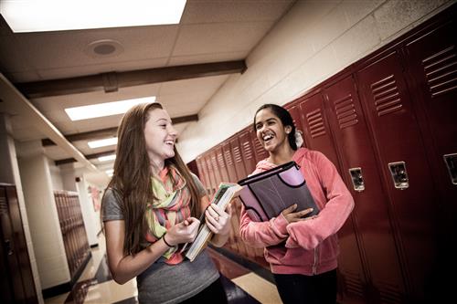 two female studnets walking down hallway 