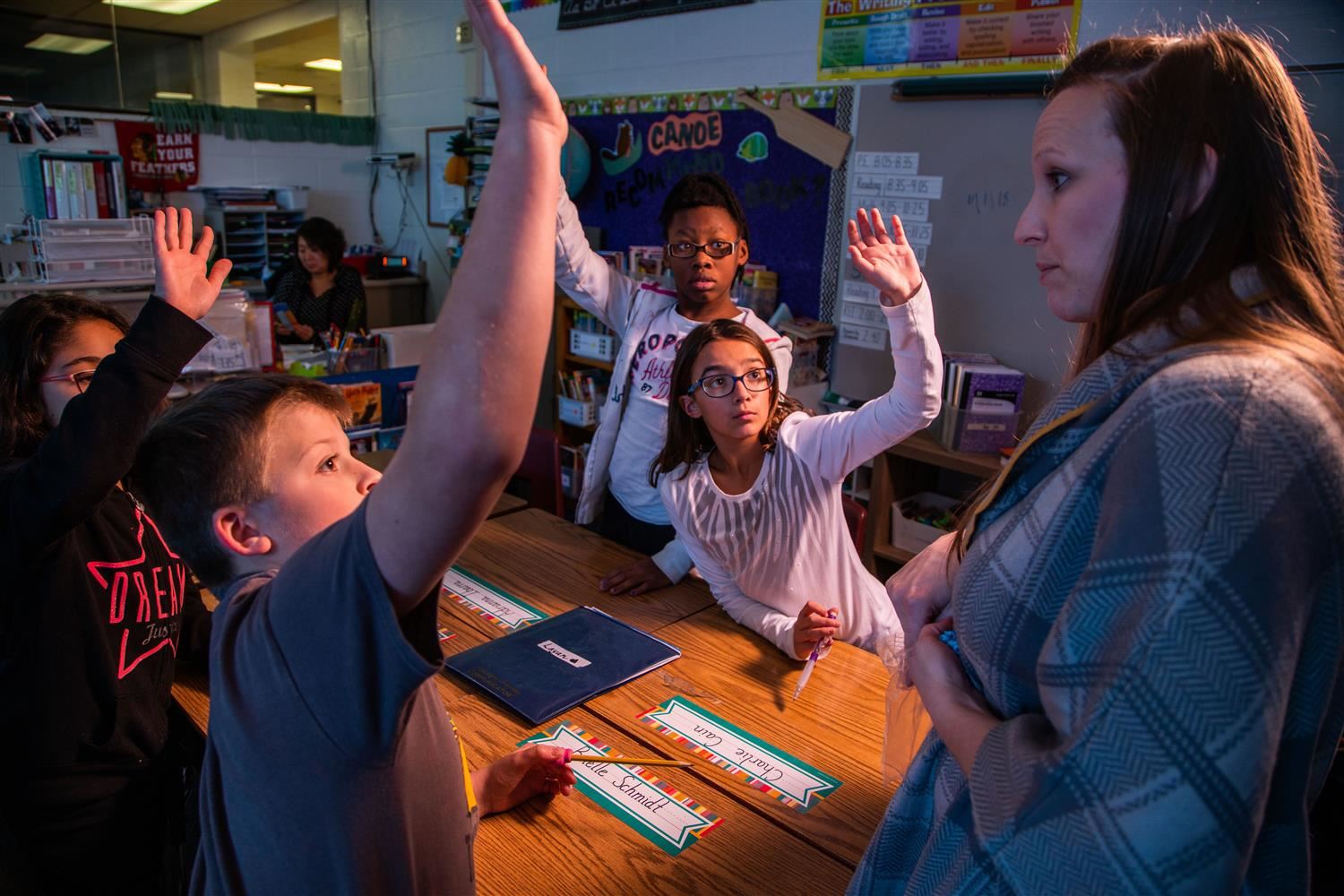 Teacher and students at desk Teacher and students at desk